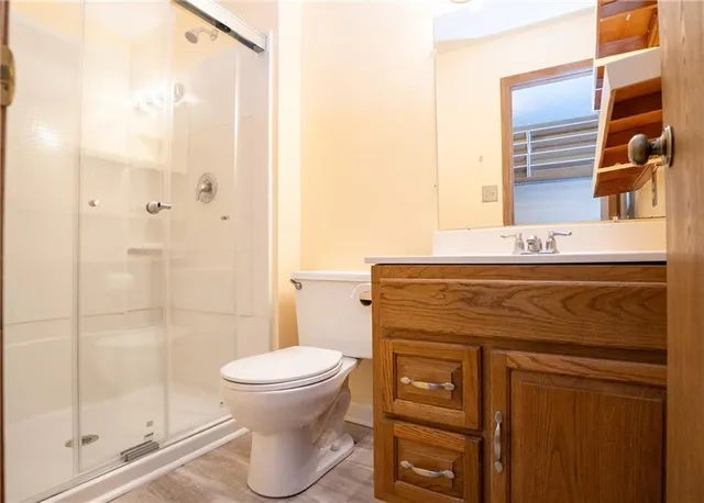 a bathroom with a toilet a sink and shower