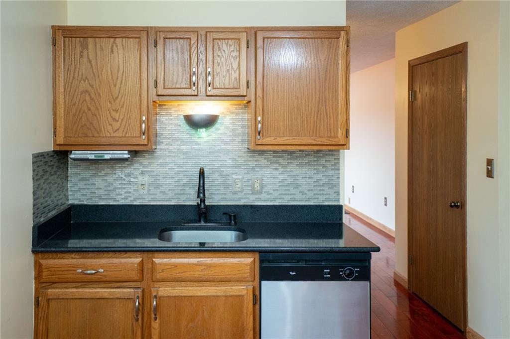 7324 Green Meadow Drive Imperial, PA 15126 - Photo 6 of 43 a kitchen with granite countertop cabinets and black appliances