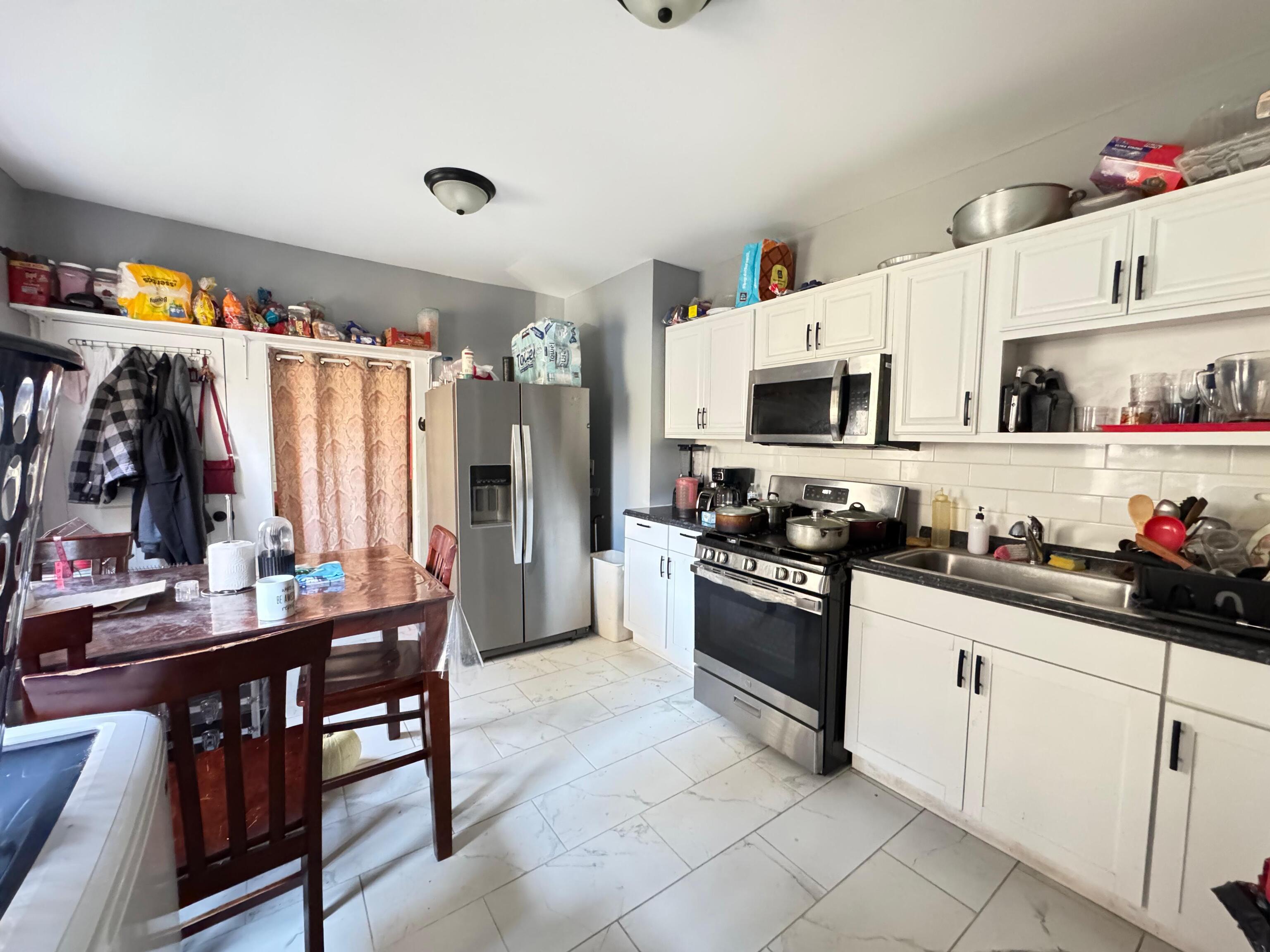 409 Poplar Street New Haven, CT 06513 - Photo 11 of 14 a kitchen with stainless steel appliances a stove top oven a sink dishwasher and cabinets