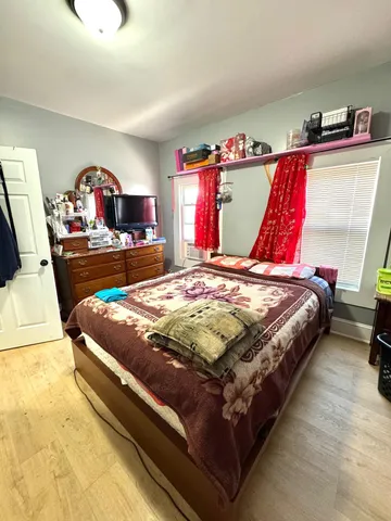 a bed sitting in a bedroom next to a window