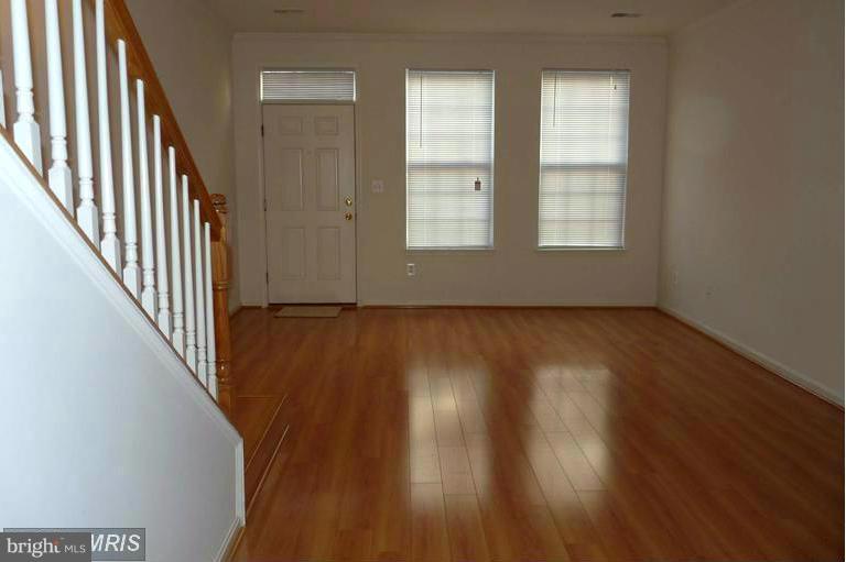 wooden floor in an empty room with windows