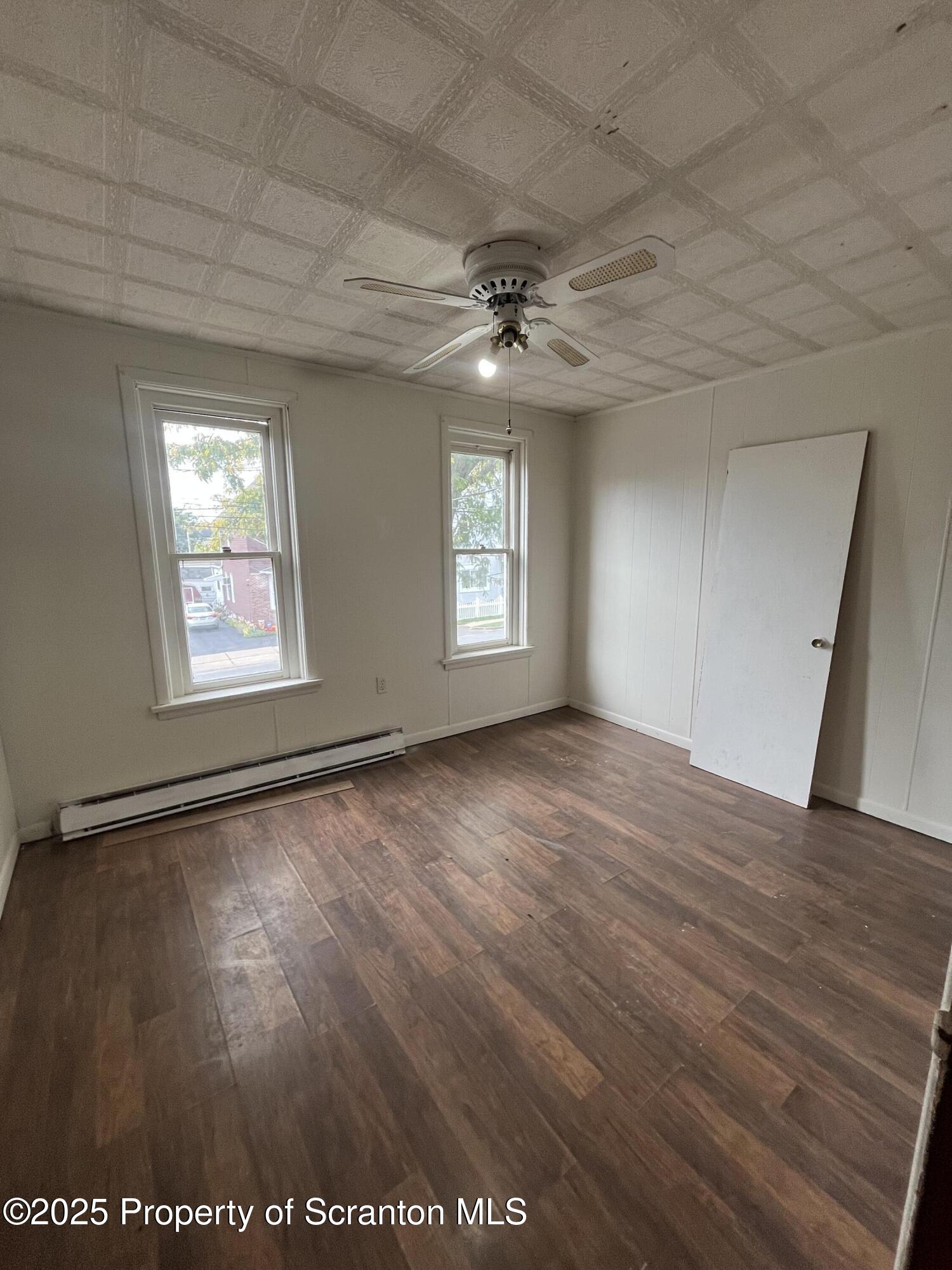 219 Ash Street Scranton, PA 18509 - Photo 7 of 11 a view of an empty room with a window and wooden floor
