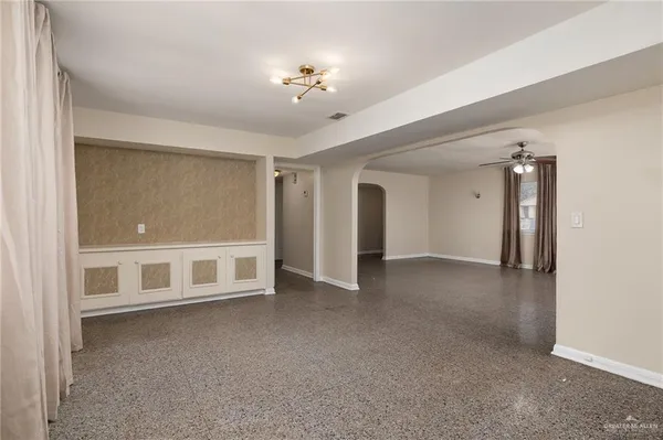 a view of an empty room with a chandelier