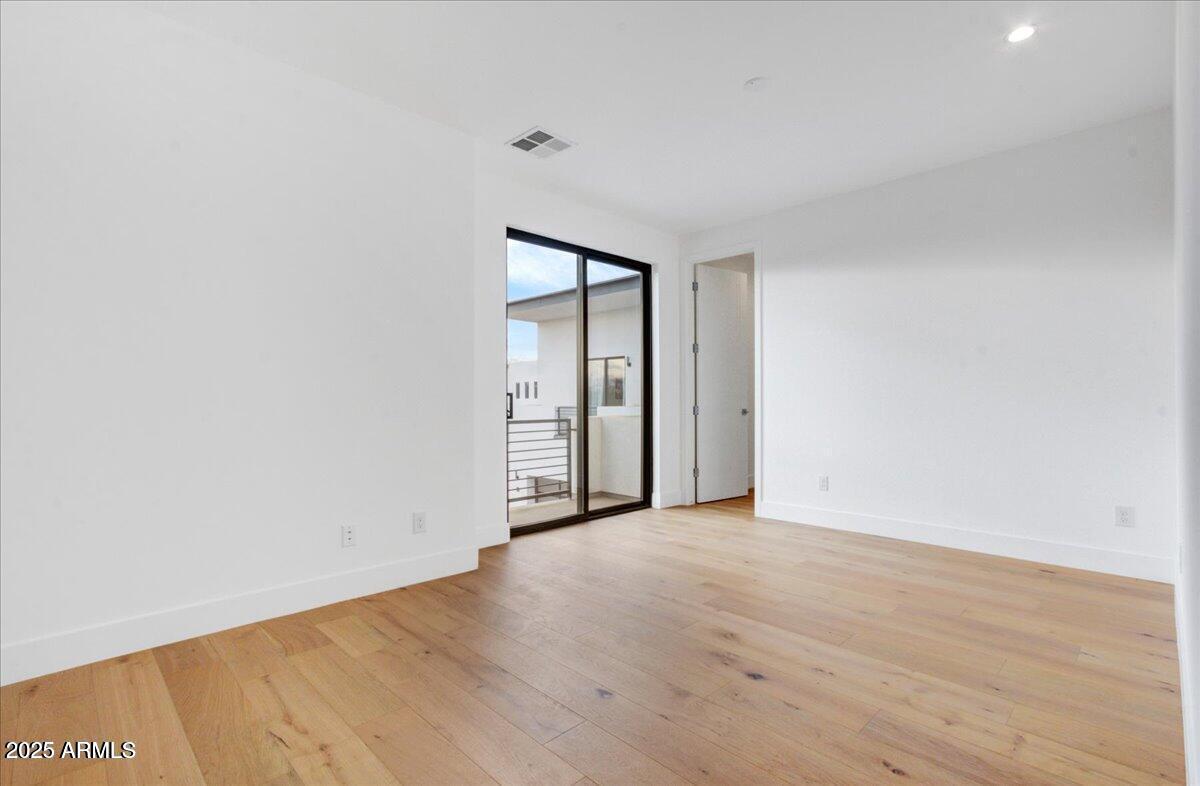 100 West Northern Avenue, Unit 4 Phoenix, AZ 85021 - Photo 15 of 25 a view of an empty room with wooden floor and a window