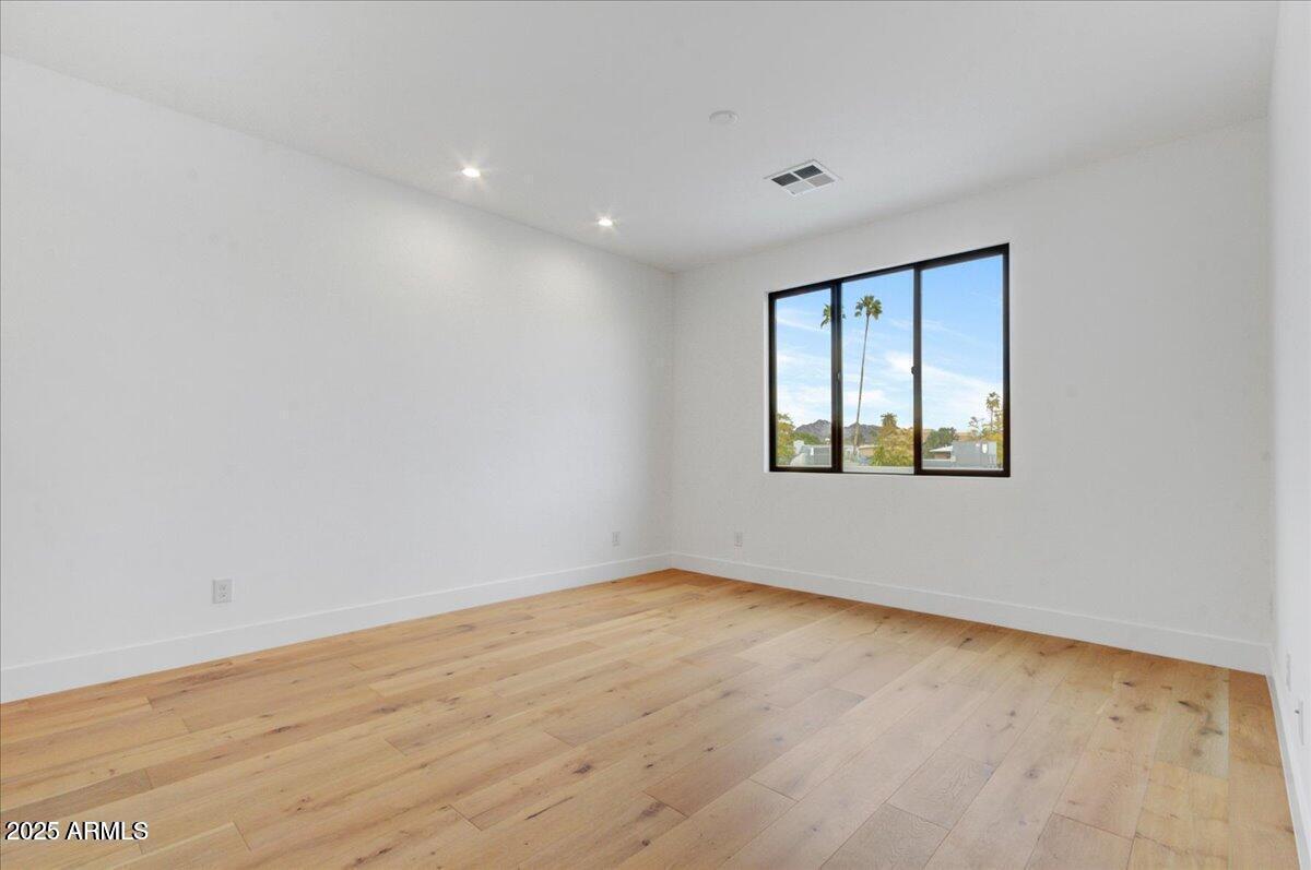 100 West Northern Avenue, Unit 4 Phoenix, AZ 85021 - Photo 17 of 25 an empty room with wooden floor and windows
