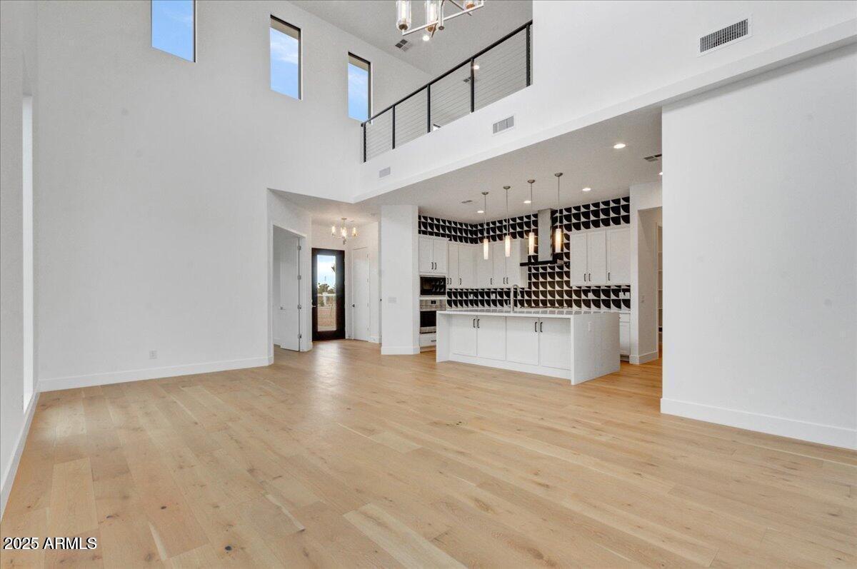 100 West Northern Avenue, Unit 4 Phoenix, AZ 85021 - Photo 2 of 25 a view of a kitchen with kitchen island a sink wooden floor and stainless steel appliances