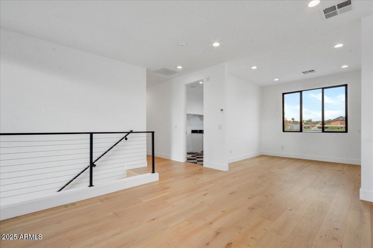 100 West Northern Avenue, Unit 4 Phoenix, AZ 85021 - Photo 8 of 25 a view of an empty room with wooden floor and a window