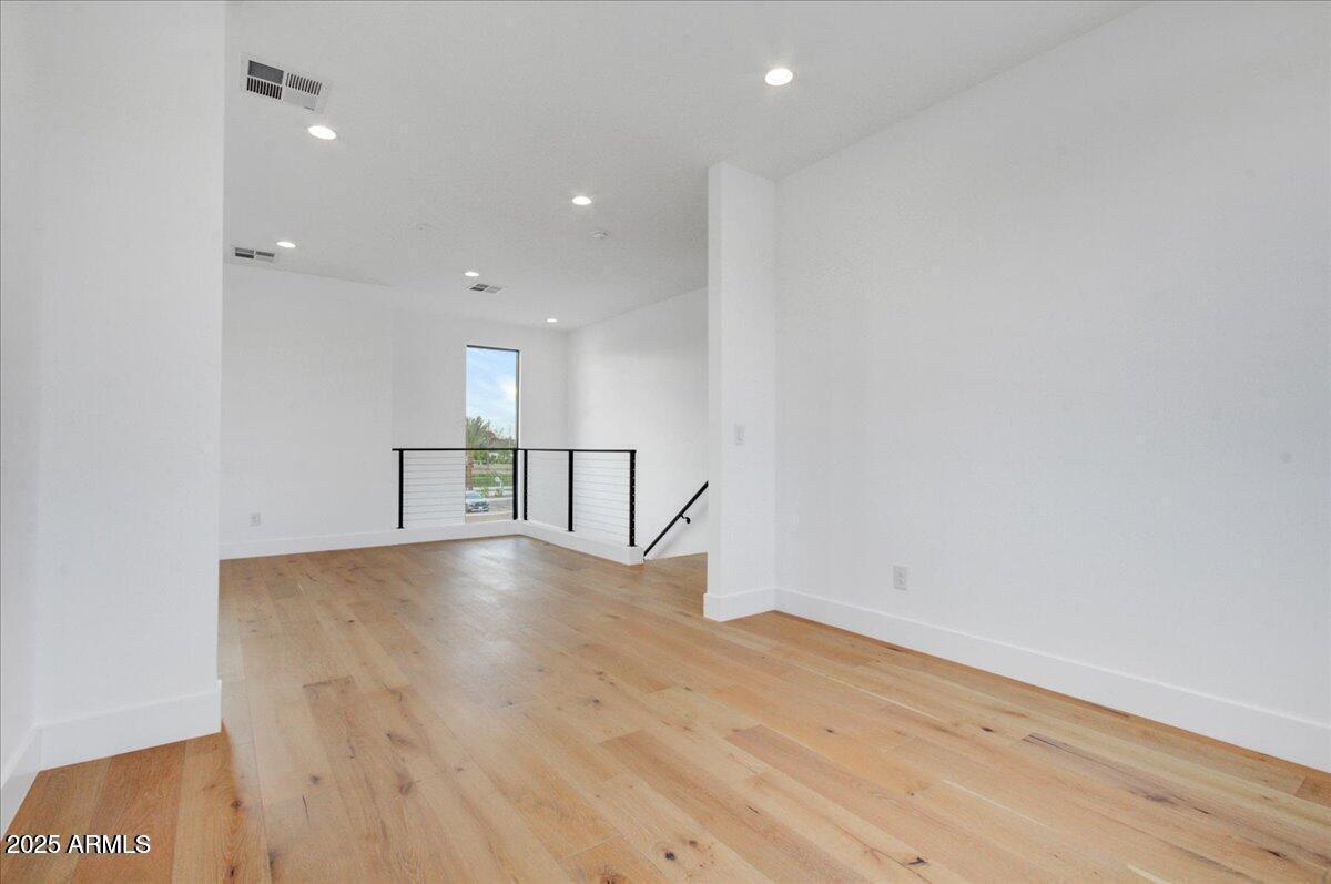 100 West Northern Avenue, Unit 4 Phoenix, AZ 85021 - Photo 10 of 25 an empty room with wooden floor and windows