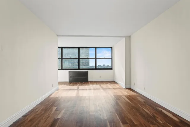 a view of a room with wooden floor