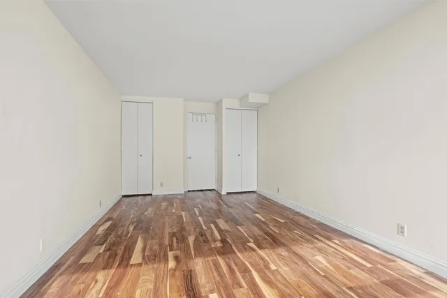 a view of an empty room and wooden floor