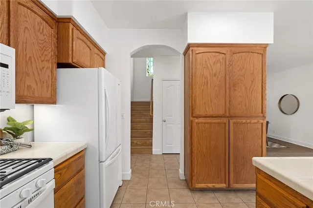 a view of a kitchen with cabinets and refrigerator