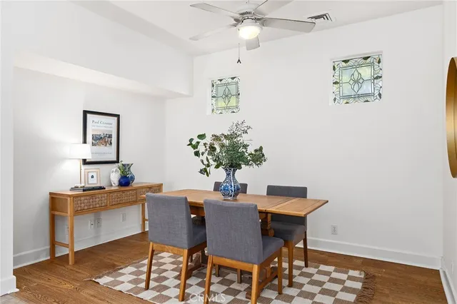 a dining room with furniture and wooden floor