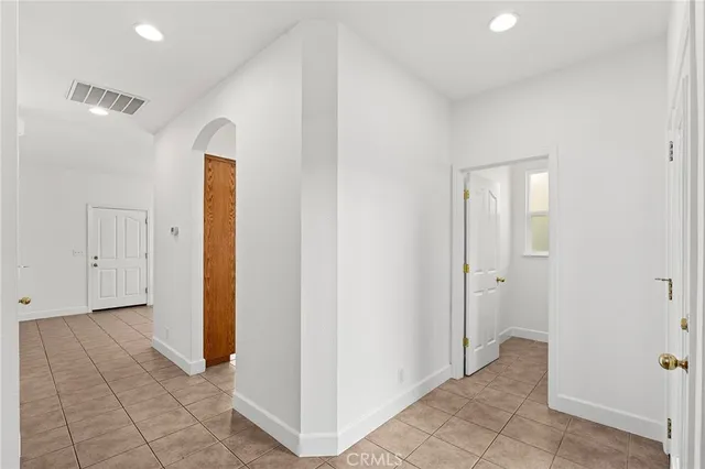 a view of a hallway with closet and bathroom