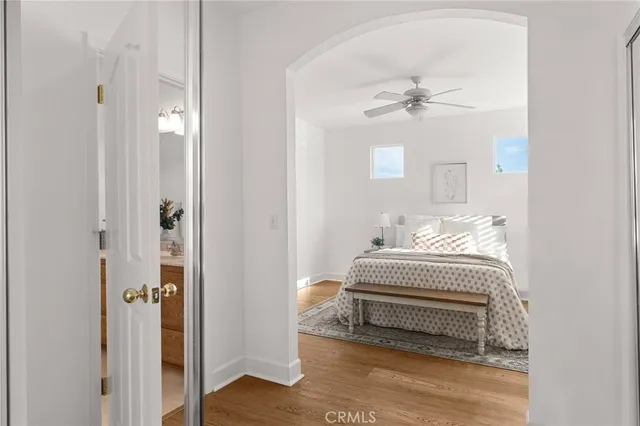 a bedroom with a white bed and a chandelier
