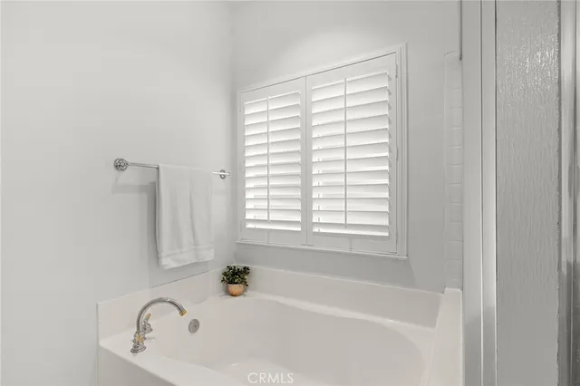 a white bath tub sitting next to a window