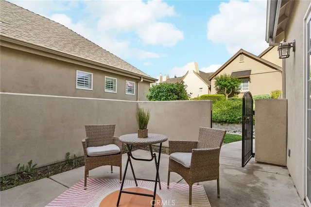 a backyard of a house with table and chairs