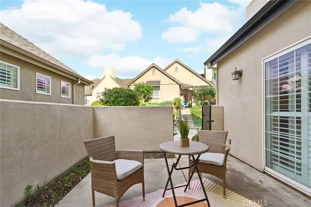 a view of a patio with a table and chairs