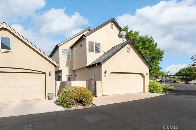a view of a hallway with white walls and a window