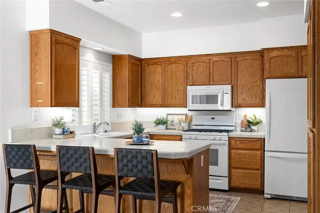 a kitchen with a sink stove and refrigerator