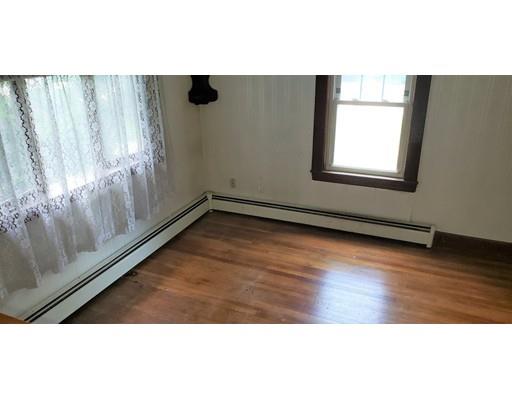 48 Mt Walley Road Waltham, MA 02451 - Photo 14 of 23 a view of an empty room with wooden floor and a window