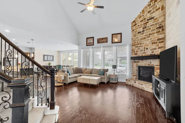 a living room with fireplace furniture and a flat screen tv