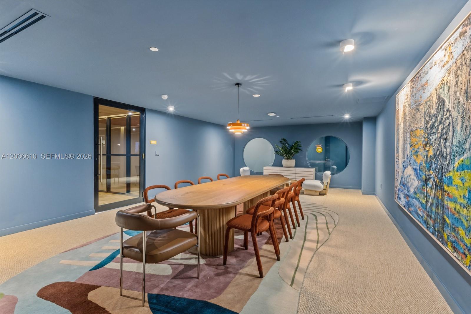 90 Northeast 32nd Street, Unit 1014 Miami, FL 33127 - Photo 21 of 39 a view of a dining room with furniture and wooden floor