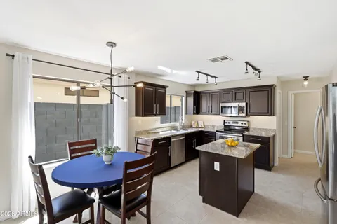 a kitchen with stainless steel appliances granite countertop a stove top oven a sink and dishwasher