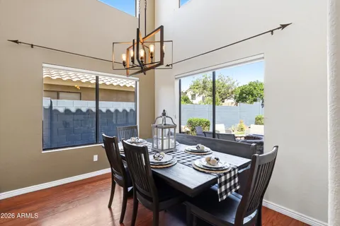a kitchen with stainless steel appliances kitchen island granite countertop a table chairs and a refrigerator