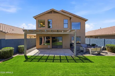 a view of a house with a yard and sitting area
