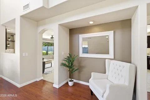 a living room with furniture a dining table and a large window