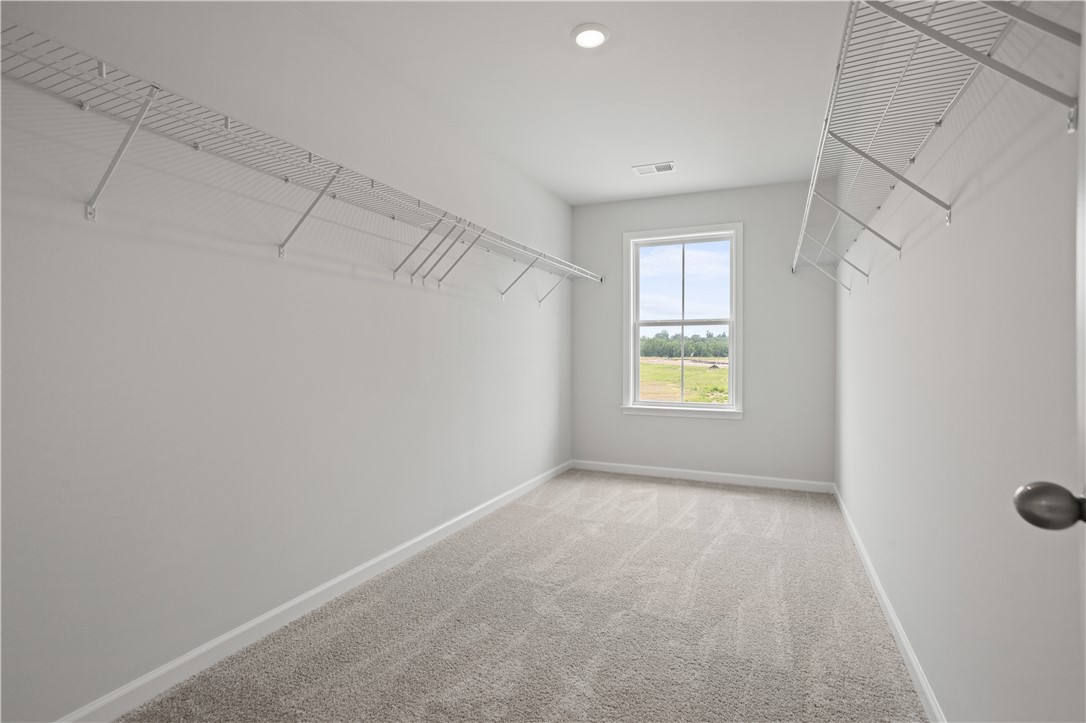 555 Hydrangea Street, Unit LOT 47 Seneca, SC 29678 - Photo 26 of 38 Ample shelving and natural light create a spacious, inviting closet area.