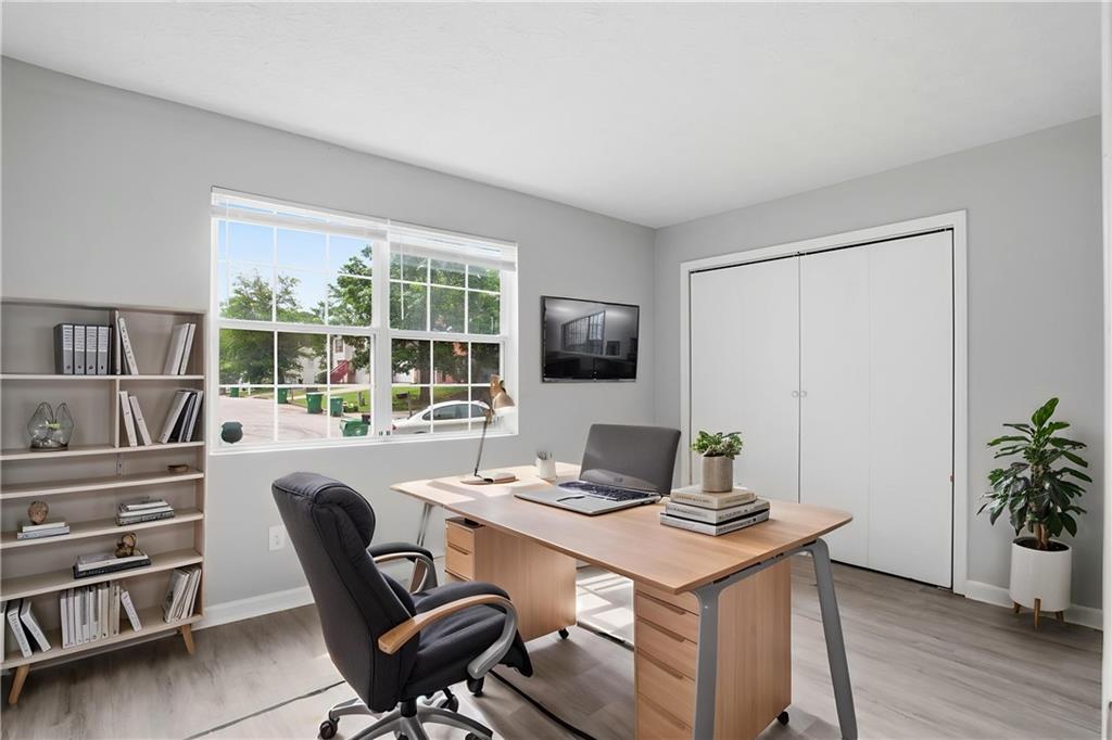 5855 Crescent Ridge Court Lithonia, GA 30058 - Photo 7 of 46 a view of a workspace with furniture and a potted plant