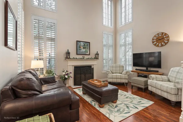 a living room with furniture a flat screen tv and a fireplace