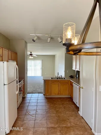 a kitchen with stainless steel appliances granite countertop a refrigerator a stove and a sink