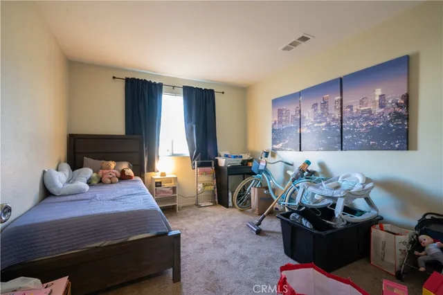 a bedroom with furniture and a wooden floor