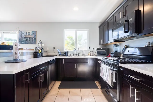 a kitchen with stainless steel appliances a sink stove and cabinets