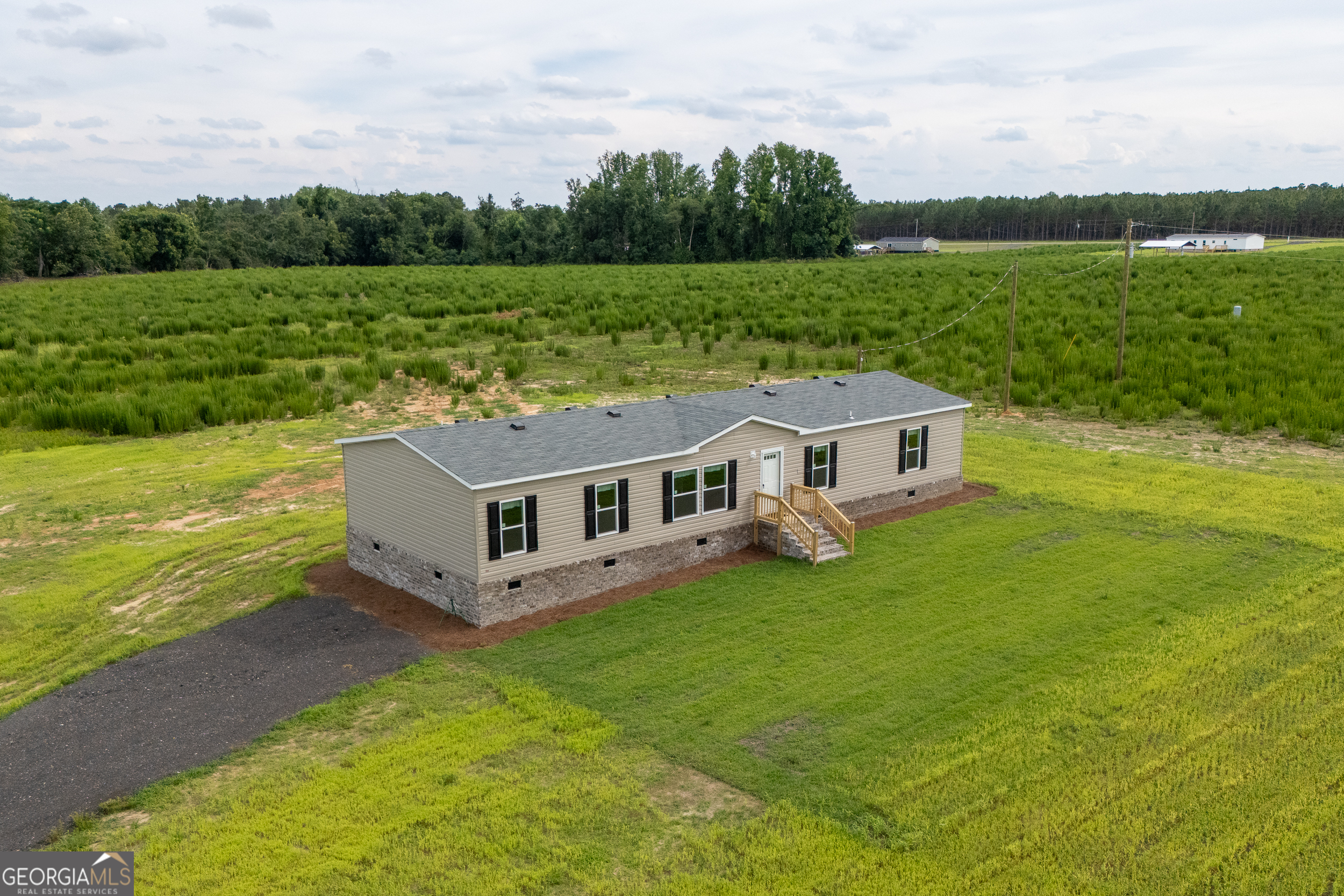 244 Ivey Hall Clark Road Garfield, GA 30425 - Photo 2 of 34 a aerial view of a house with yard and green space