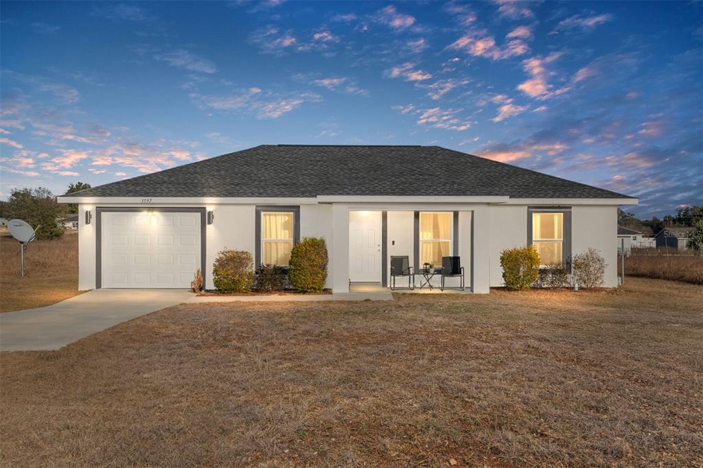 3597 Southwest 151st Avenue Ocala, FL 34481 - Photo 1 of 35 a front view of house with yard and outdoor seating