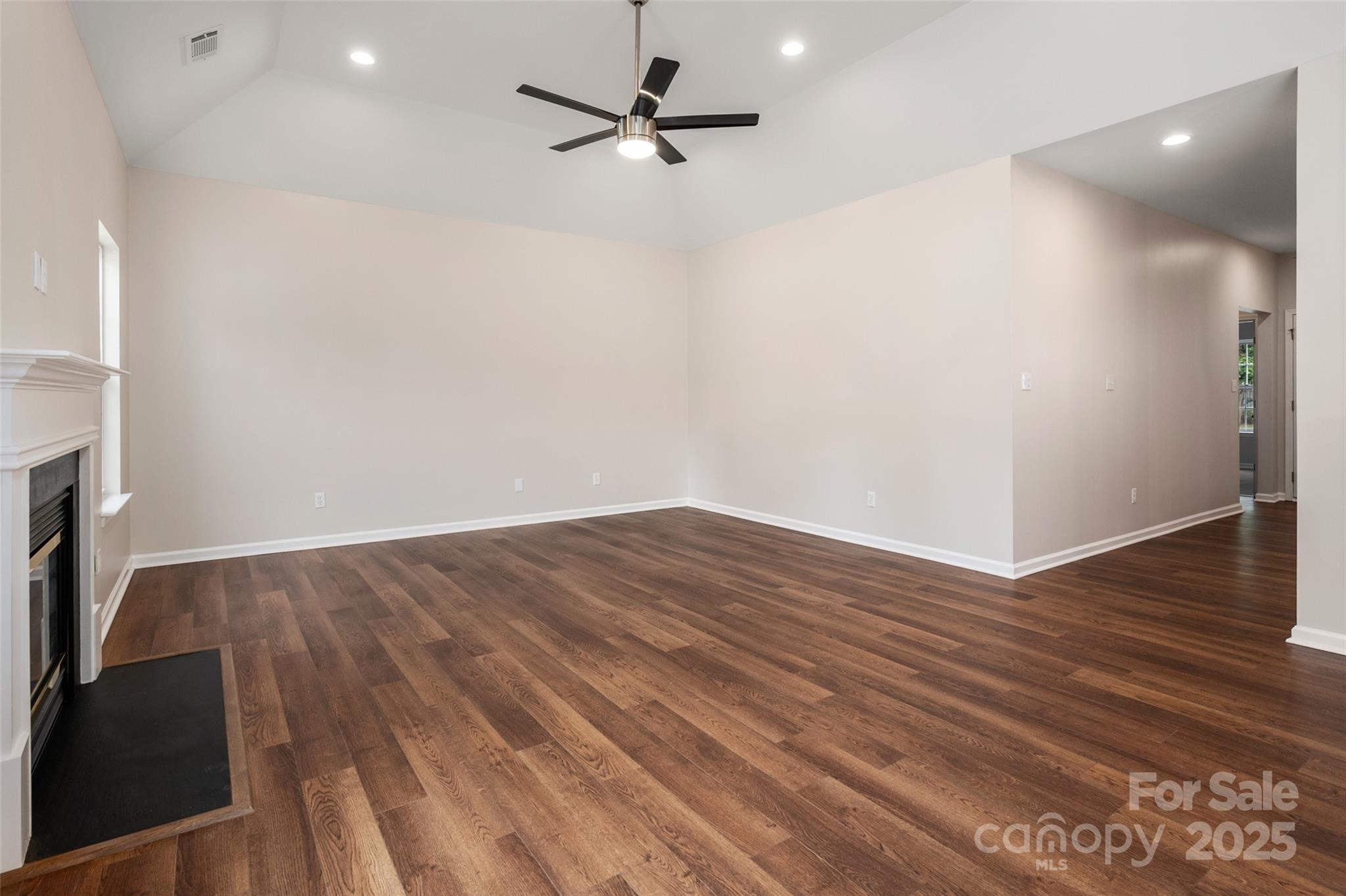 1004 Toquima Trail Monroe, NC 28110 - Photo 12 of 38 a view of a room with wooden floor and a ceiling fan