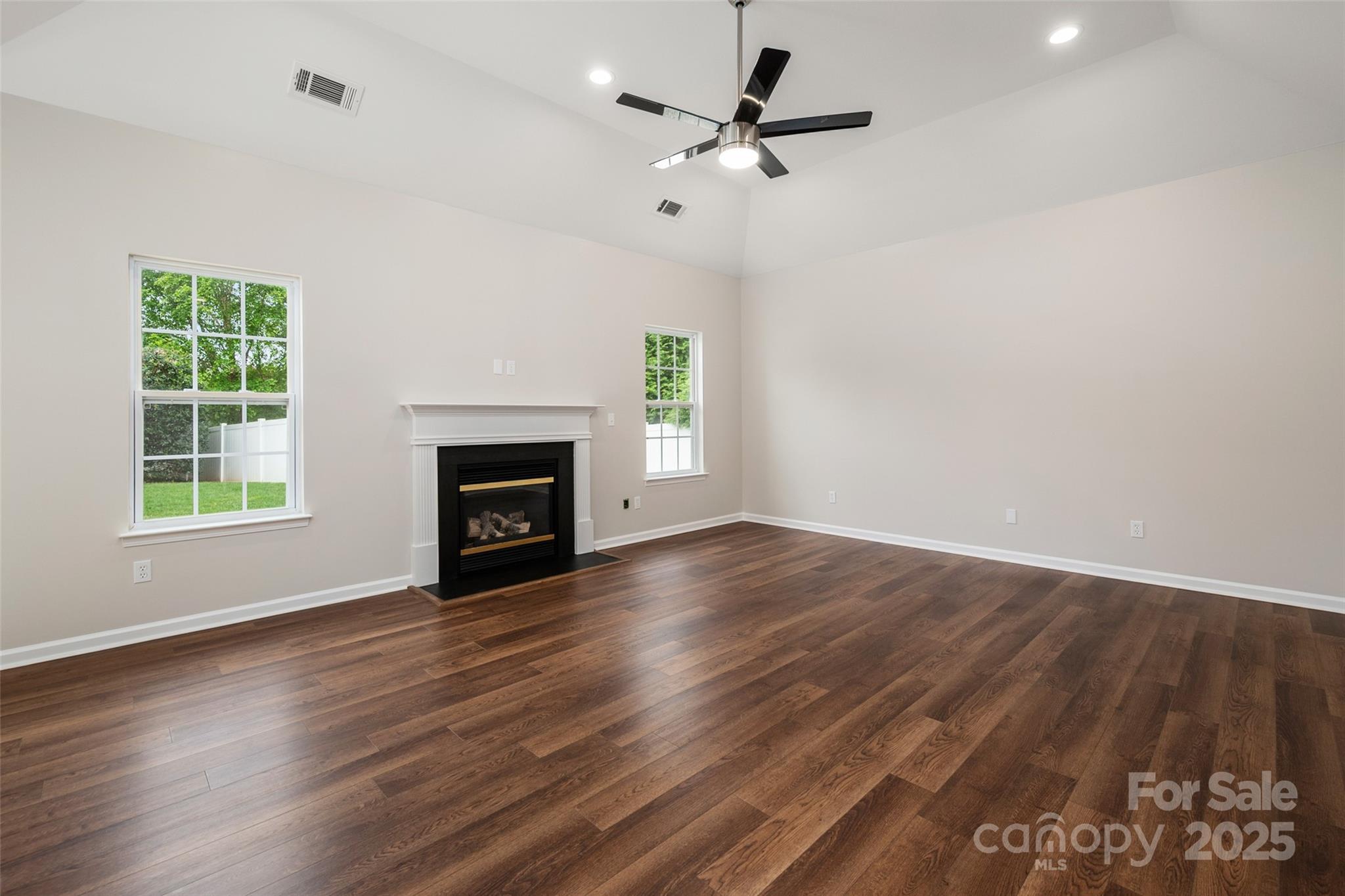 1004 Toquima Trail Monroe, NC 28110 - Photo 13 of 38 a view of empty room with wooden floor fireplace and a window