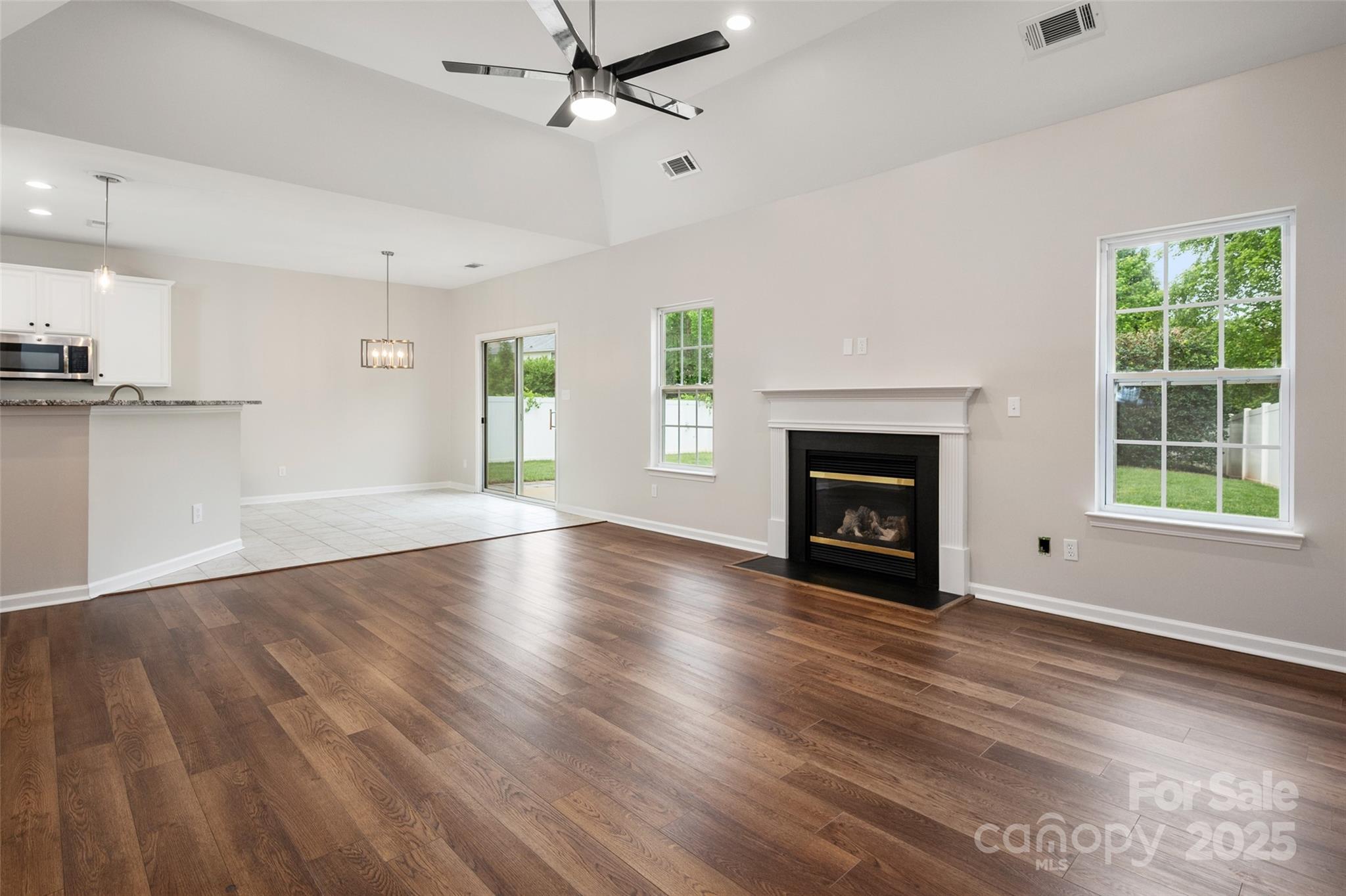 1004 Toquima Trail Monroe, NC 28110 - Photo 14 of 38 a view of an empty room with wooden floor fireplace and a window