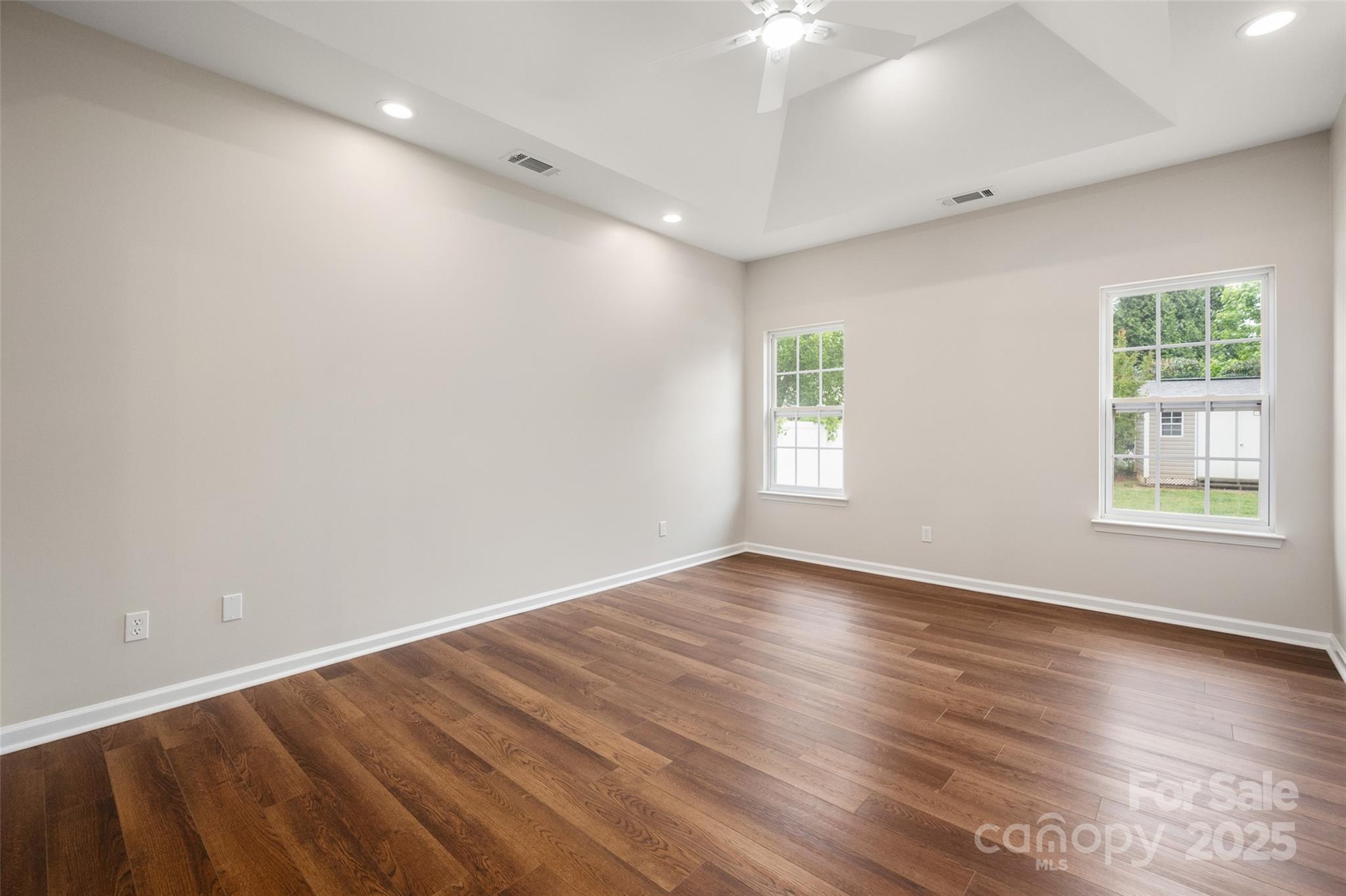 1004 Toquima Trail Monroe, NC 28110 - Photo 18 of 38 an empty room with wooden floor and windows