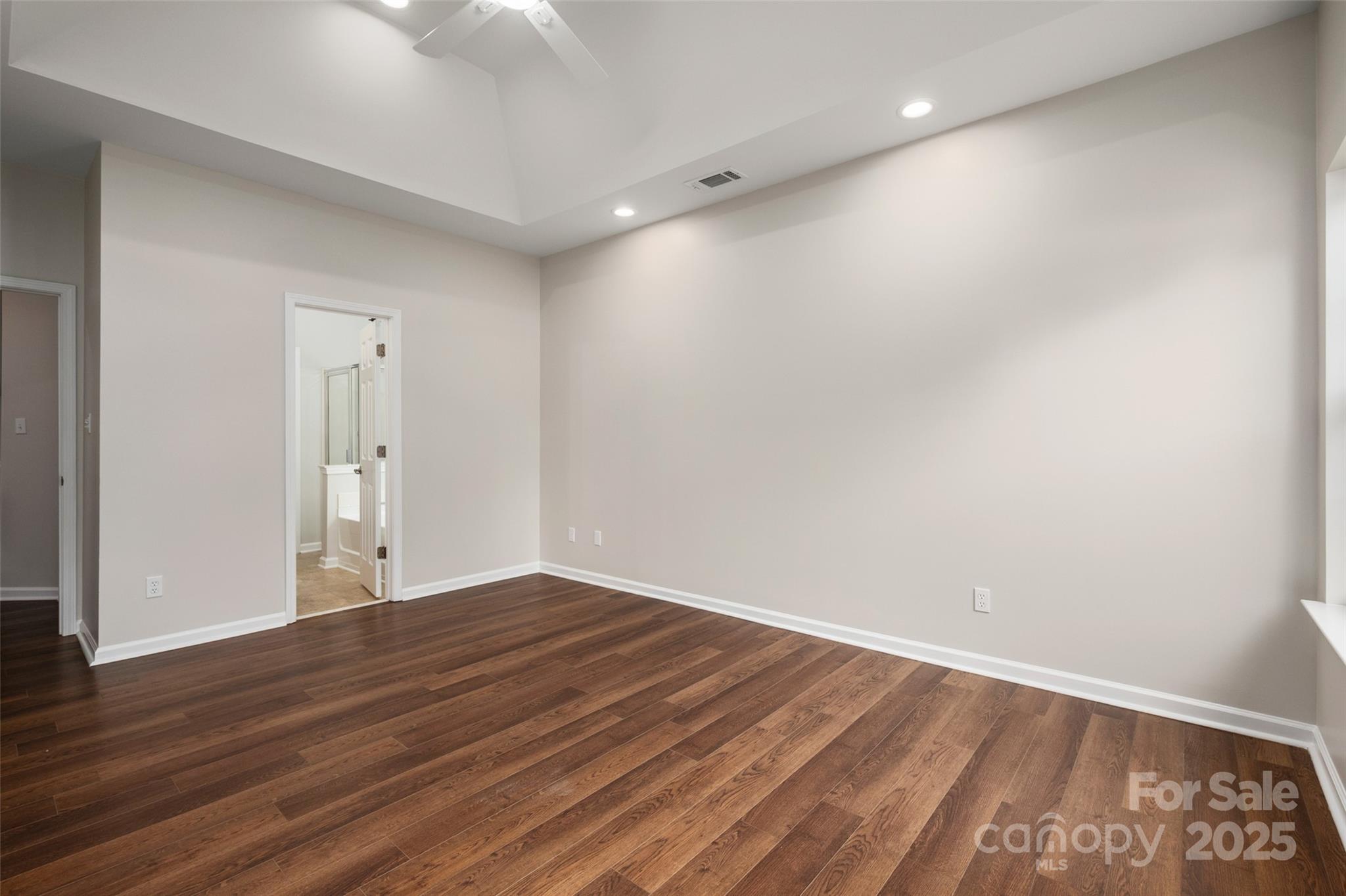 1004 Toquima Trail Monroe, NC 28110 - Photo 19 of 38 an empty room with wooden floor and windows