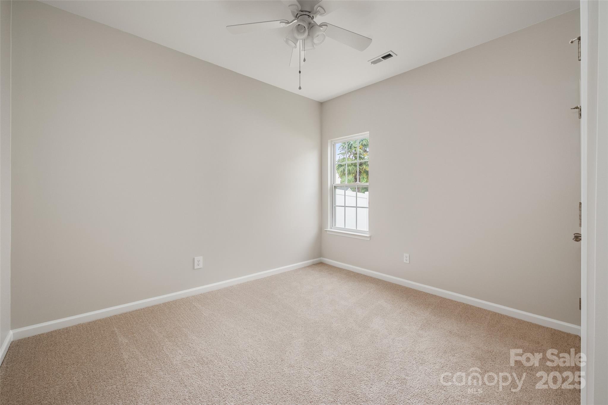 1004 Toquima Trail Monroe, NC 28110 - Photo 23 of 38 an empty room with a window and a fan