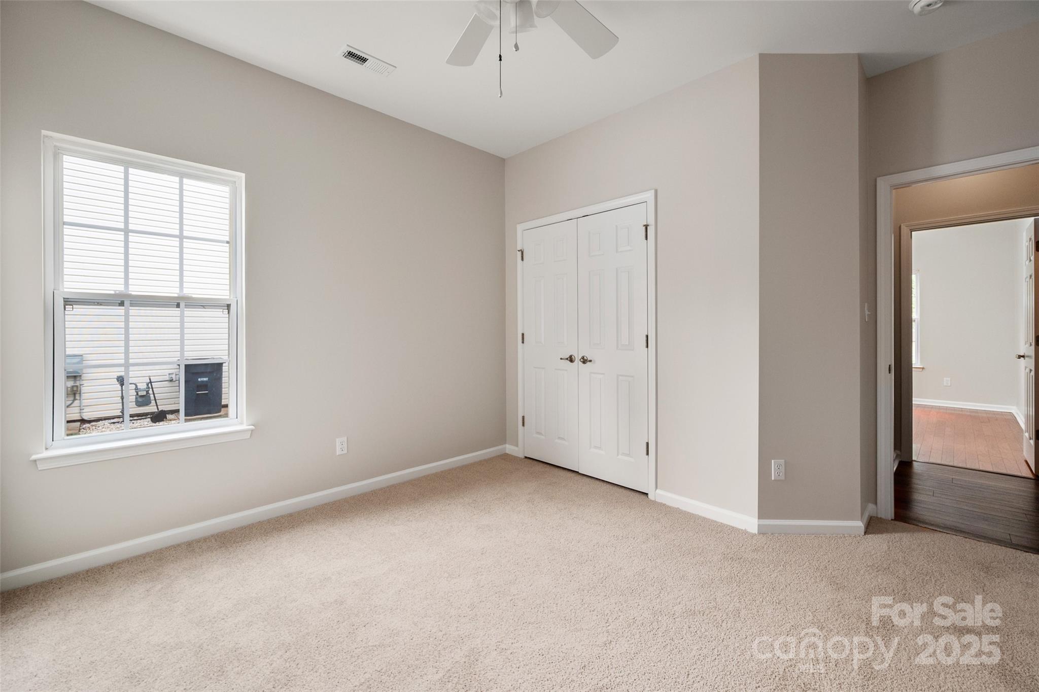 1004 Toquima Trail Monroe, NC 28110 - Photo 24 of 38 an empty room with chandelier fan and windows