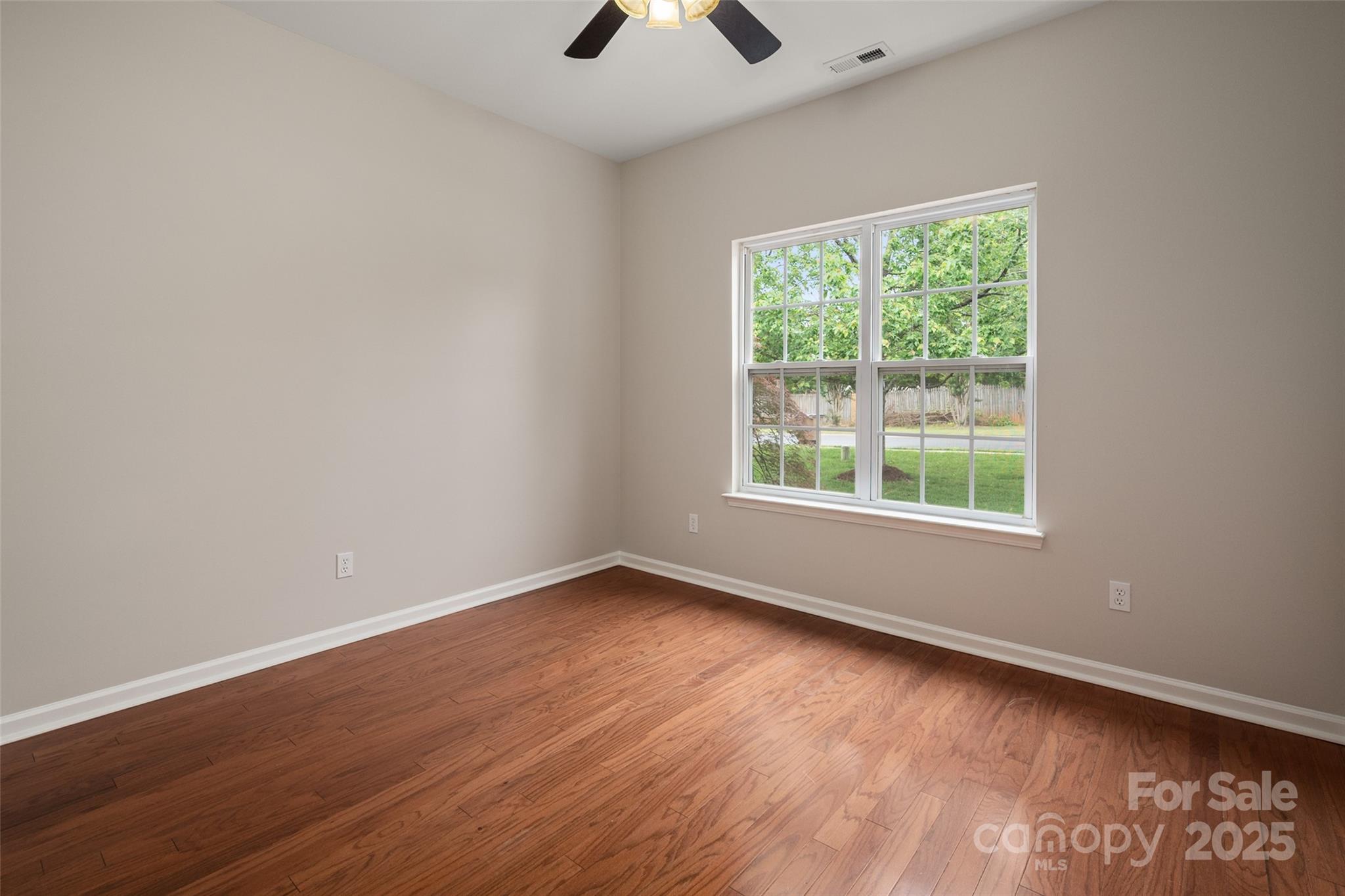 1004 Toquima Trail Monroe, NC 28110 - Photo 25 of 38 an empty room with wooden floor and windows