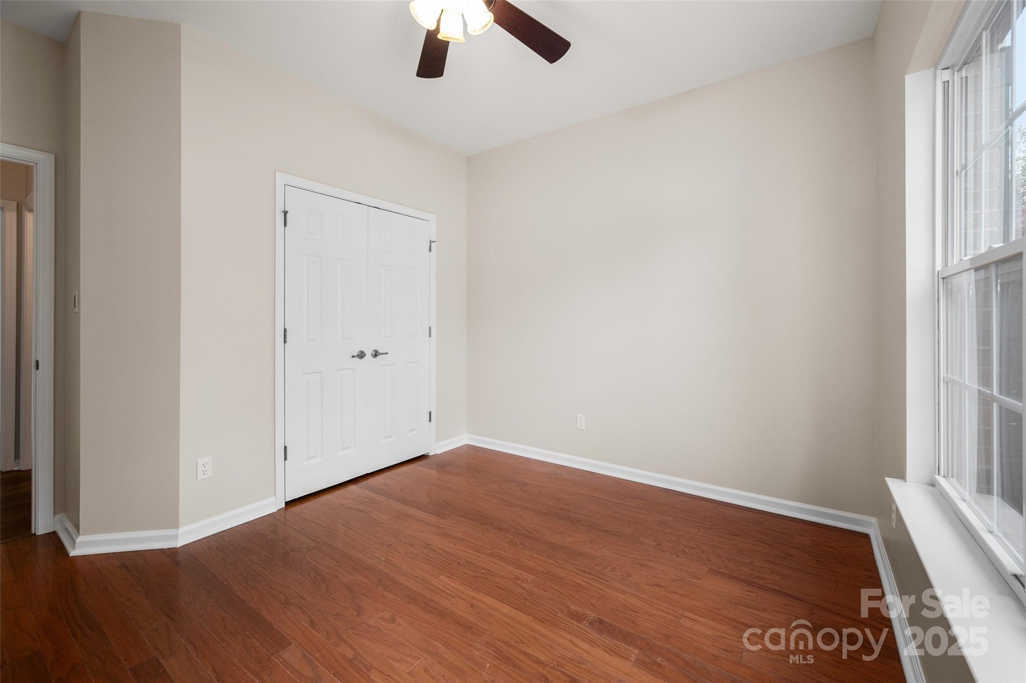 1004 Toquima Trail Monroe, NC 28110 - Photo 26 of 38 an empty room with a window and wooden floor
