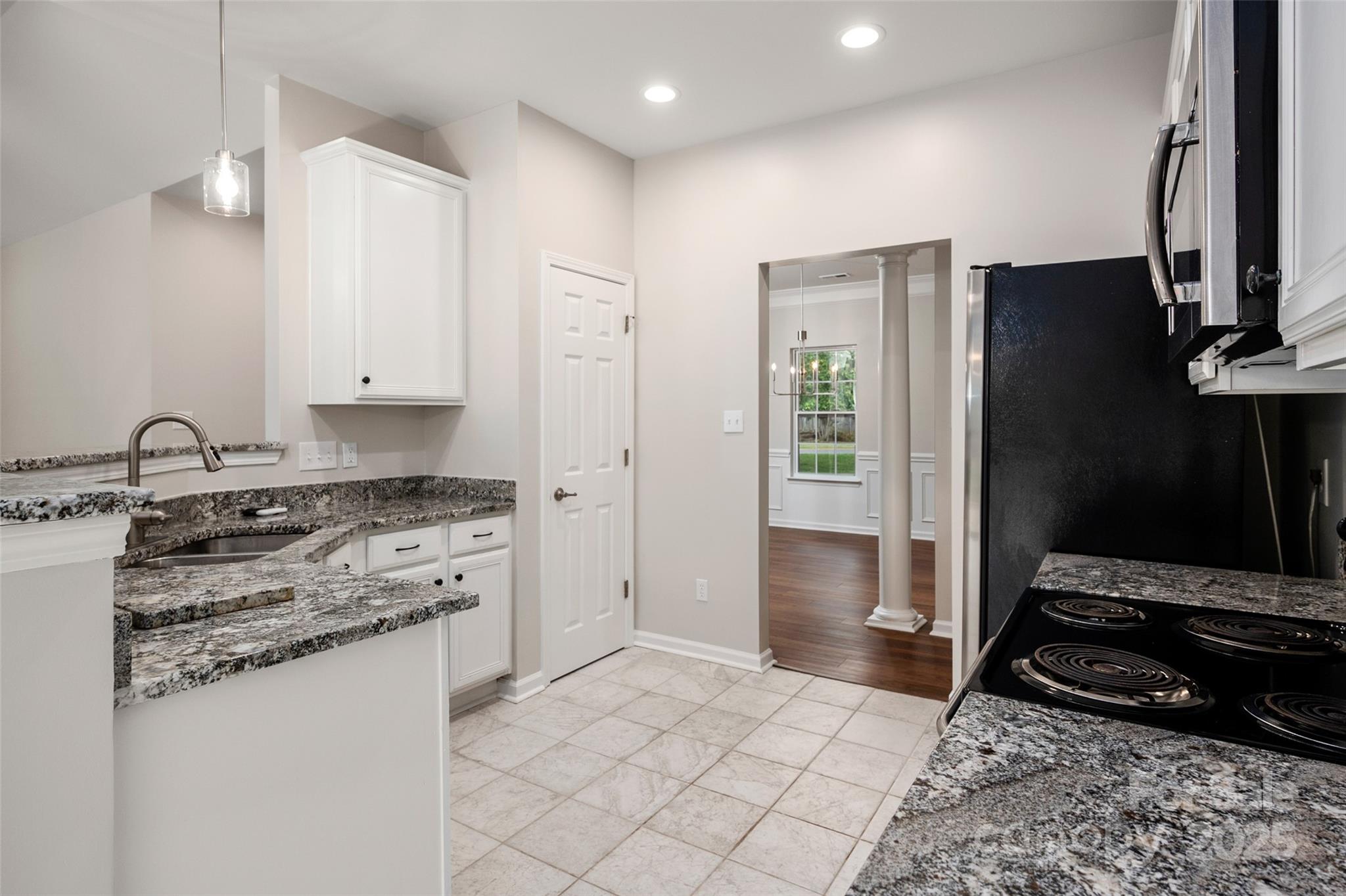 1004 Toquima Trail Monroe, NC 28110 - Photo 9 of 38 a kitchen with stainless steel appliances granite countertop a refrigerator stove and sink