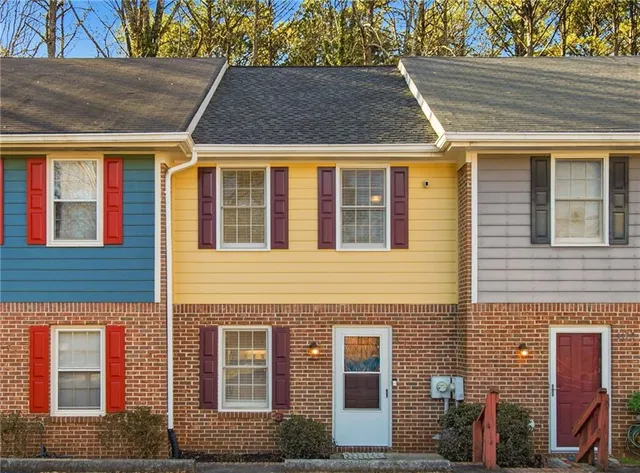 a view of a brick house with many windows