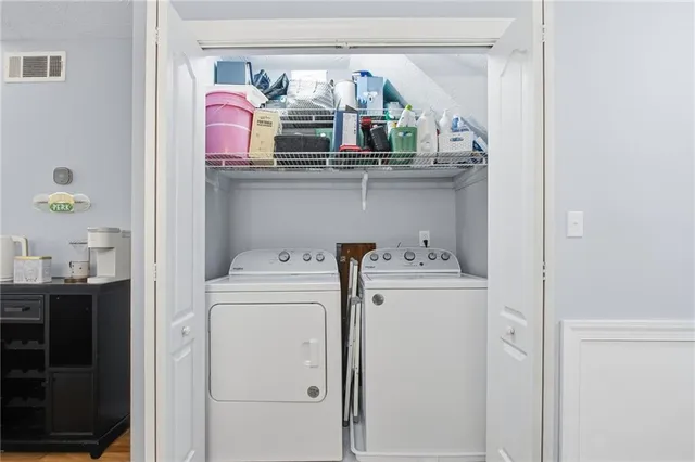 a view of washer and dryer with kitchen in the background